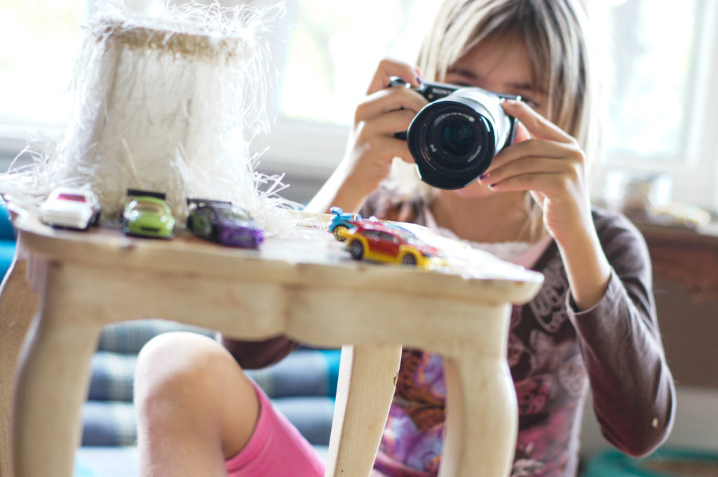 Disney's Photo Mom shares 13 fun exercises to teach kids photography. Her own kids model these tips for fun throughout the year!